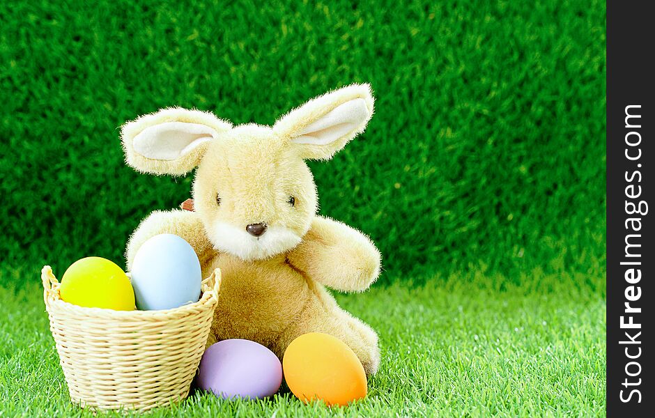 Bunny toy and Easter eggs in basket