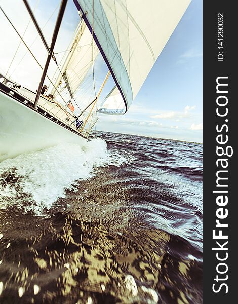 Yachting on sail boat bow stern shot splashing sea water. Sporty transportation conept. Yachting on sail boat bow stern shot splashing sea water. Sporty transportation conept