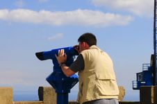 Man Looking Through A Coin Operated Binoculars Royalty Free Stock Photography Man Looking Through A Coin Operated Binoculars Royalty Free Stock Photography