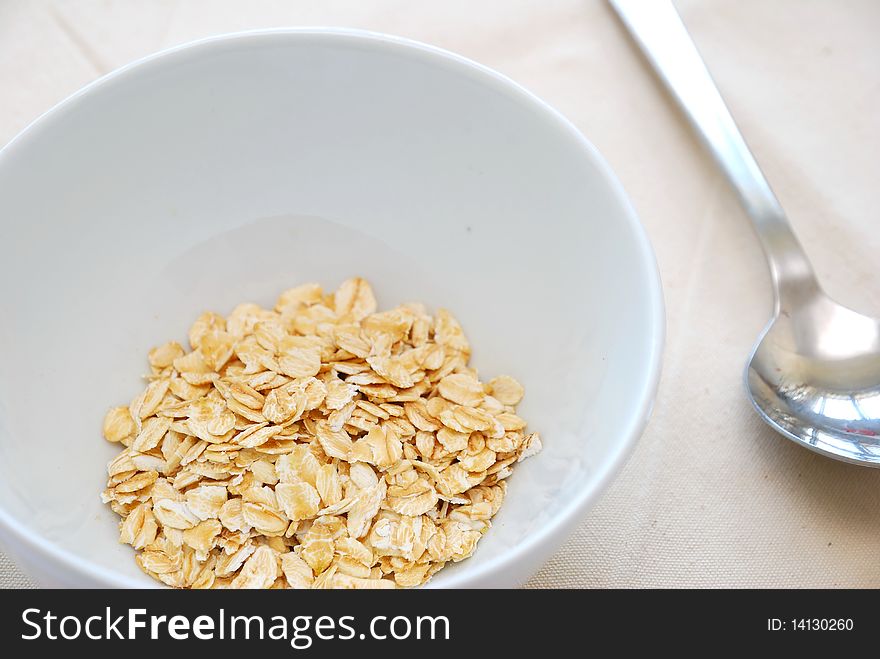 Small serving of healthy oatmeal to signify concepts such as dieting, and healthy eating and lifestyle. Also for healthy and nutritious breakfasts, nutrition, and food and beverage concepts.