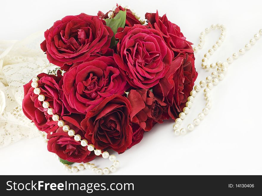 A red rose bouquet with lace and pearls on a horizontal background, perfect for Valentine's Day. A red rose bouquet with lace and pearls on a horizontal background, perfect for Valentine's Day