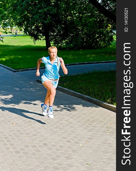 Young woman running in park. Young woman running in park