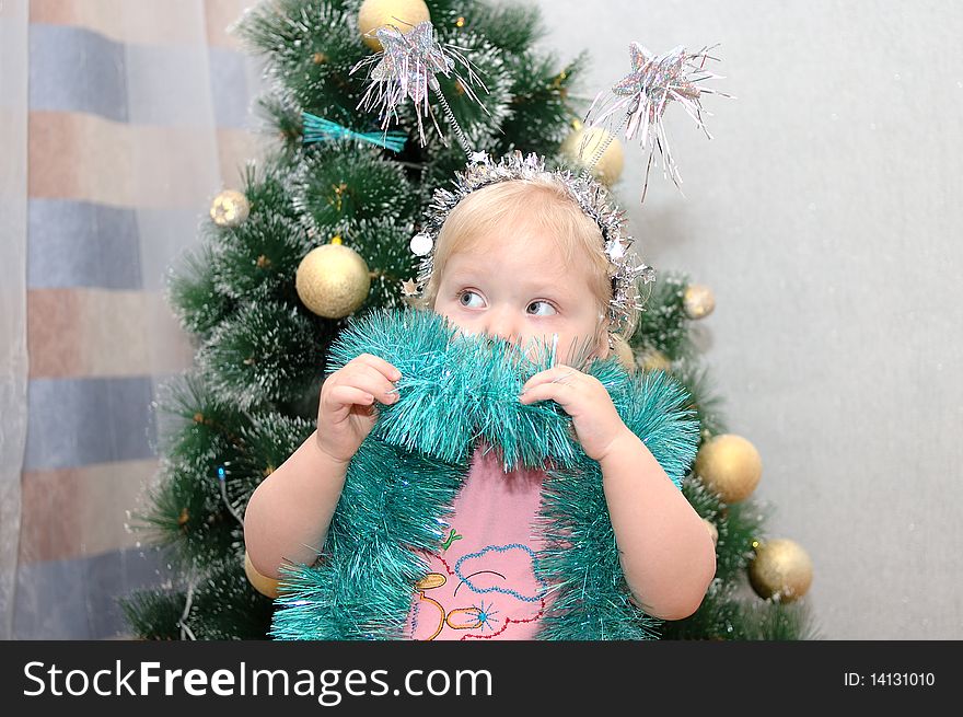 Pretty little girl with blond hair and christmas-tree. Pretty little girl with blond hair and christmas-tree.