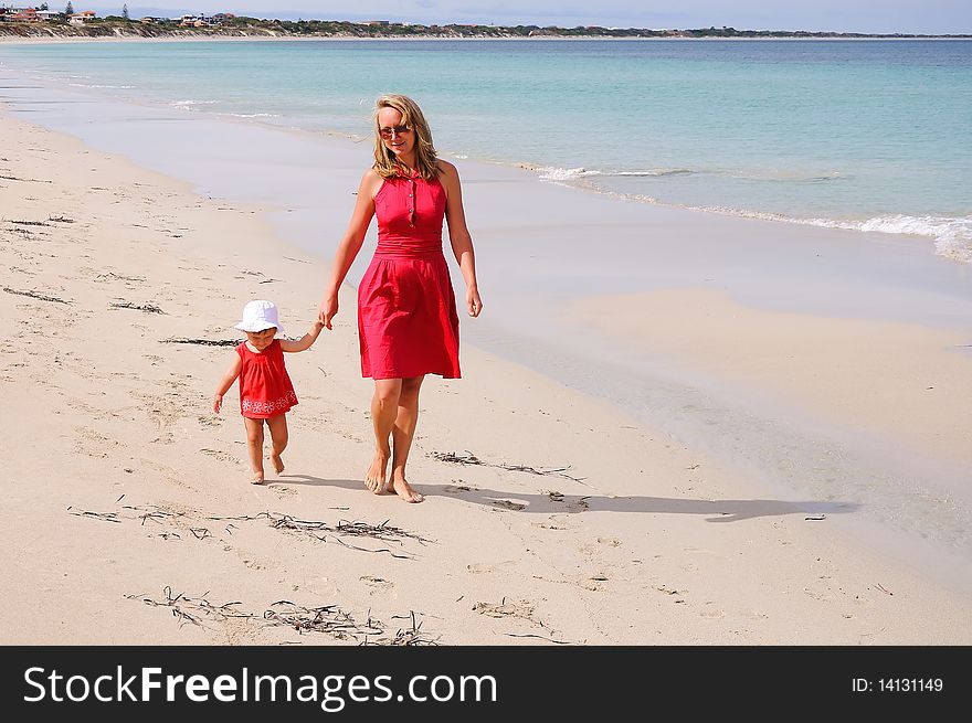 The little girl and mother near the ocean