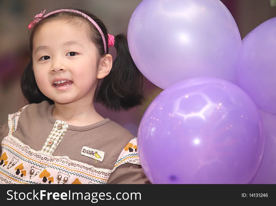 Happy children playing with balloons