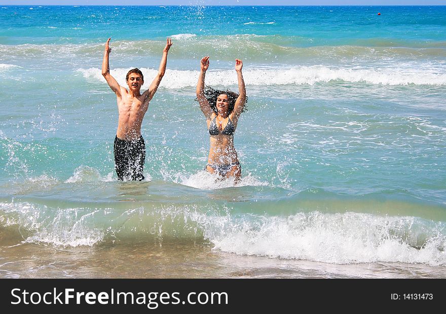 Couple walking out from  the sea.