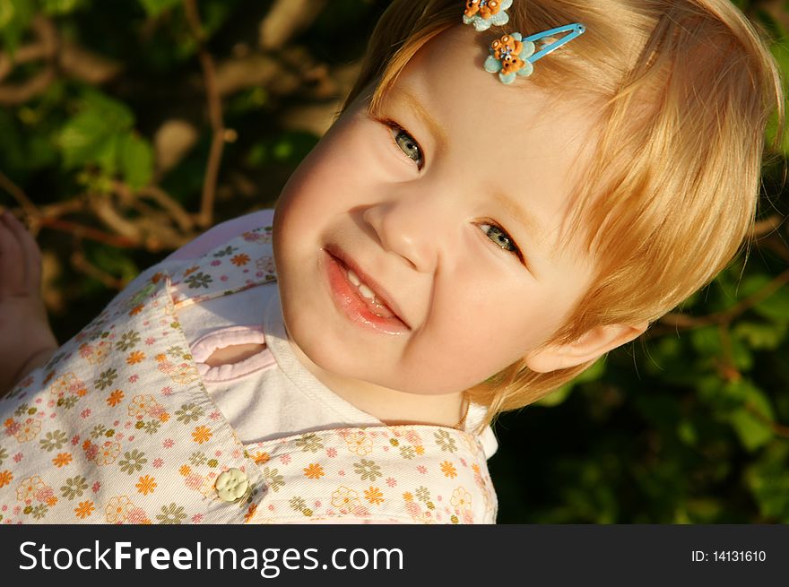 Portrait of cute little smiling girl in park, outdoor shot. Portrait of cute little smiling girl in park, outdoor shot