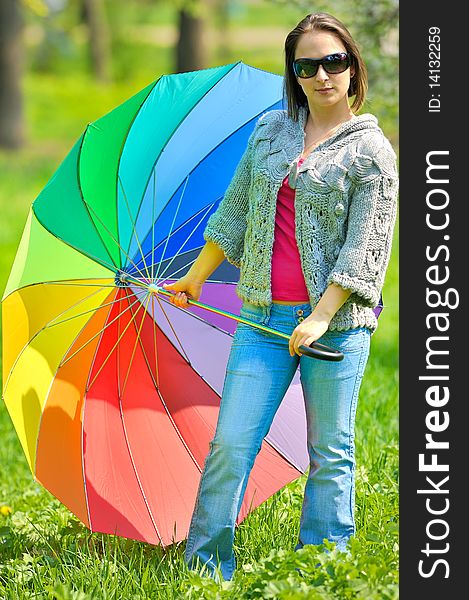 Beautiful woman with umbrella in rainbow colors