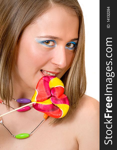 Pretty young woman with colorful lollipop, indoor shoot
