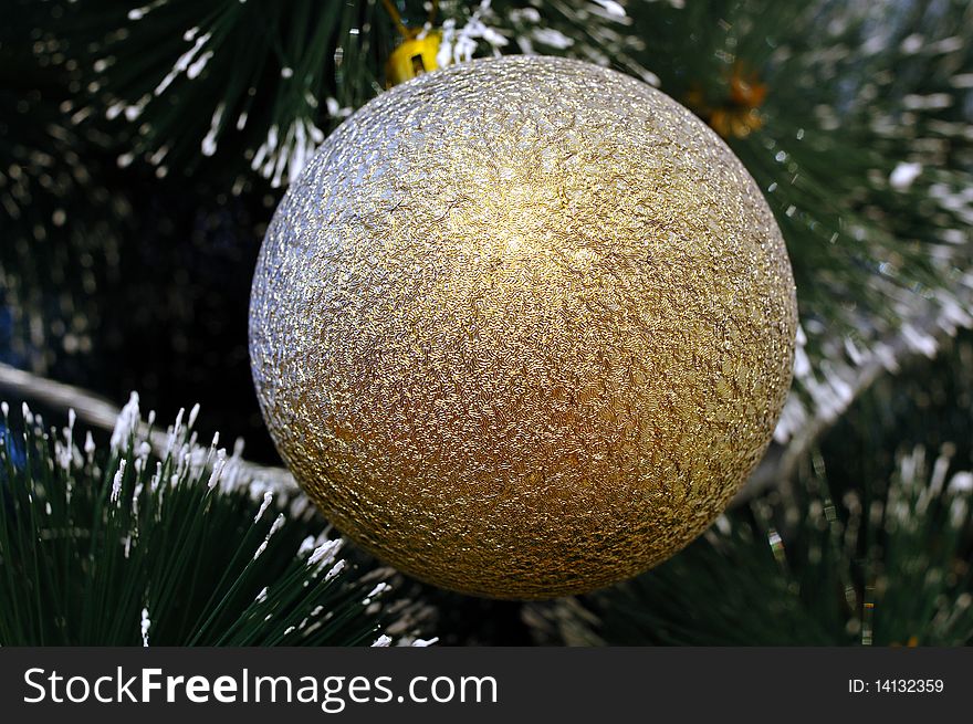 Christmas-tree and golden decoration (ball).