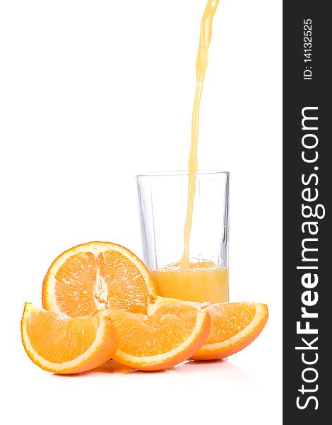 Yellow orange slices and half juice in glass