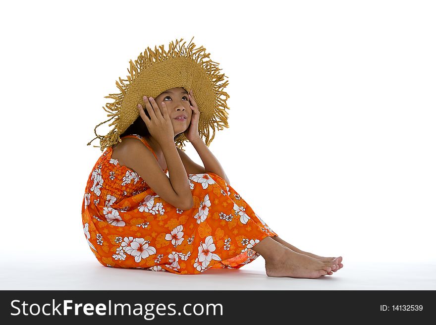 Cute girl sitting on the floor with straw hat and looking up to the ceiling, isolated on white background. Cute girl sitting on the floor with straw hat and looking up to the ceiling, isolated on white background