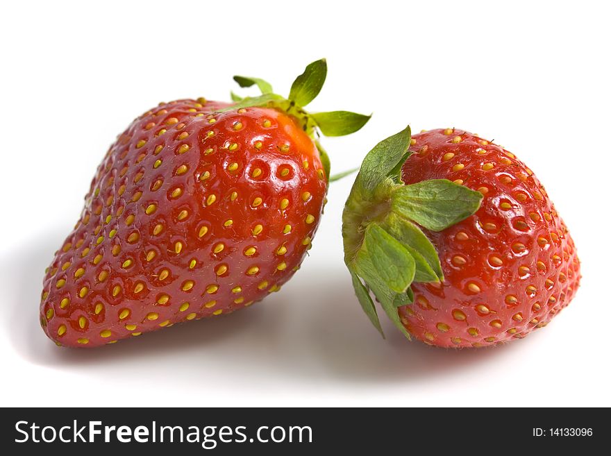 Two ripe and appetizing strawberries. A photo close up.
