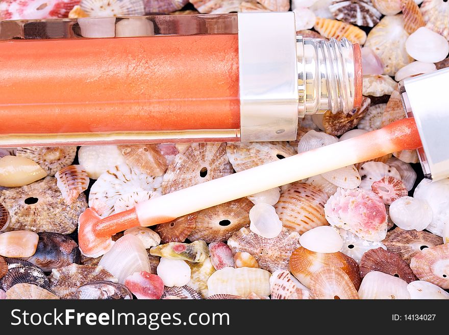 Closed-up lip gloss on seashell background