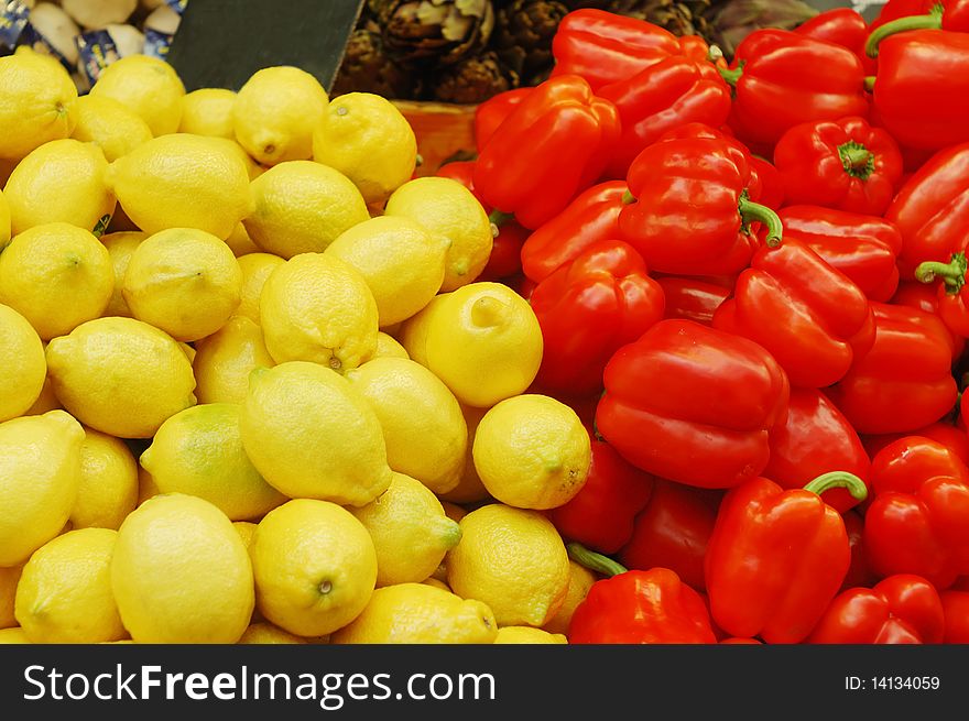 Close up of lemons and red peppers on market stand