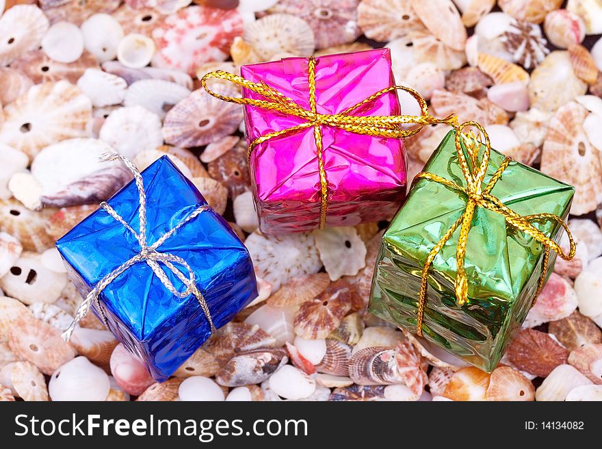 Closed-up present boxes on seashell background