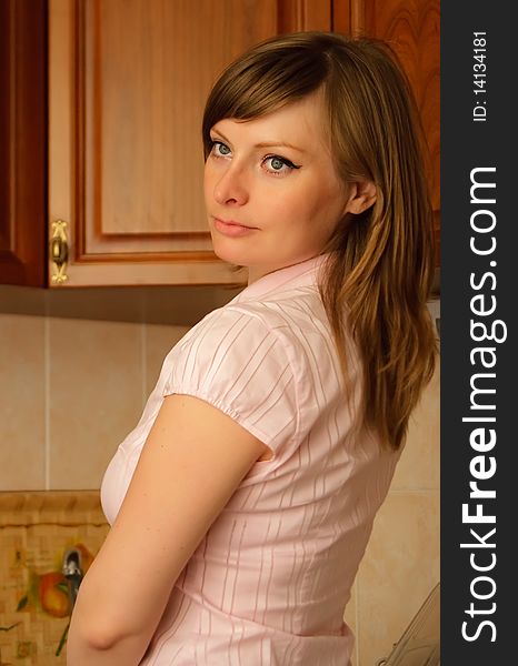 Beautiful woman in the kitchen look through