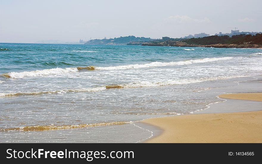 Surf on the bank of the Mediterranean sea in summer day. Coasta Dourada. Spain. Surf on the bank of the Mediterranean sea in summer day. Coasta Dourada. Spain.