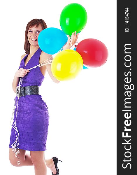 Beautiful woman posing in violet dress with a color balloons in her hands. studio work