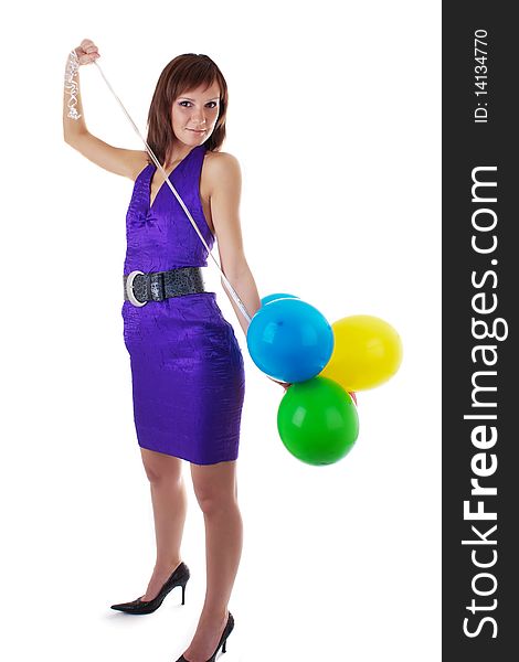 Smiling beautiful woman posing in violet dress with a color balloons in her hands. studio work