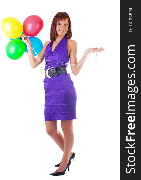 Smiling beautiful woman posing in violet dress with a color balloons in her hands. studio work