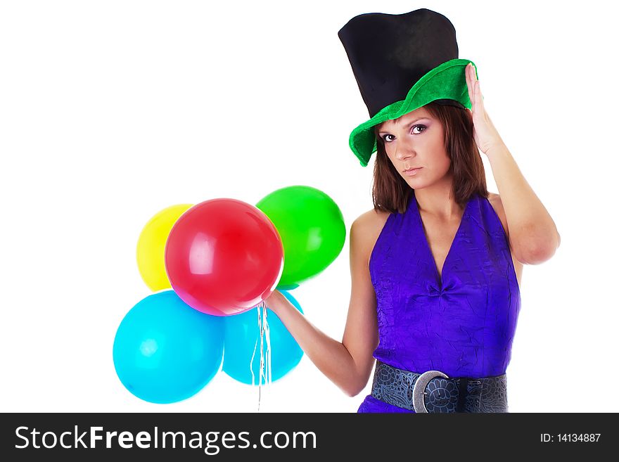 Portrait of a beautiful woman posing in hat and violet dress with a color balloons in her hands. studio work