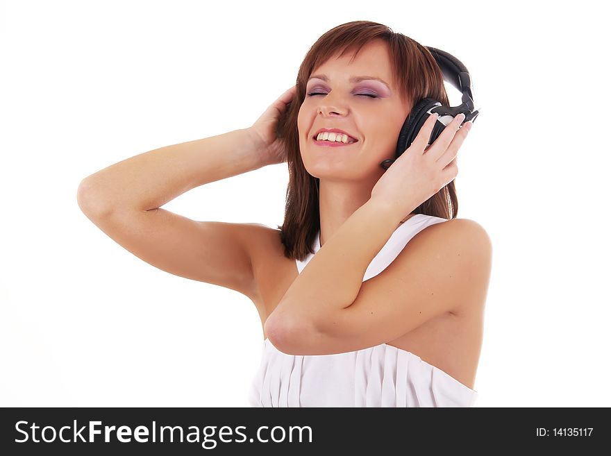 Close up Portrait of a beautiful woman listening music in headphones and white dress isolated on a white background