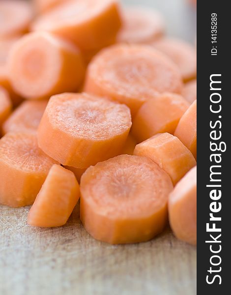 Chopped carrot in circles on wooden board