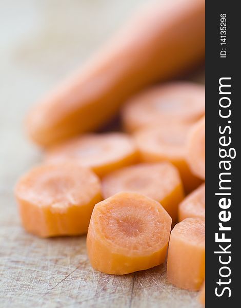 Chopped carrot in circles on wooden board