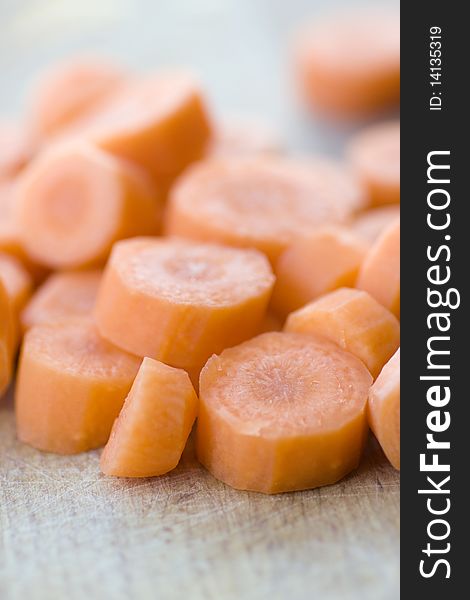 Chopped carrot in circles on wooden board