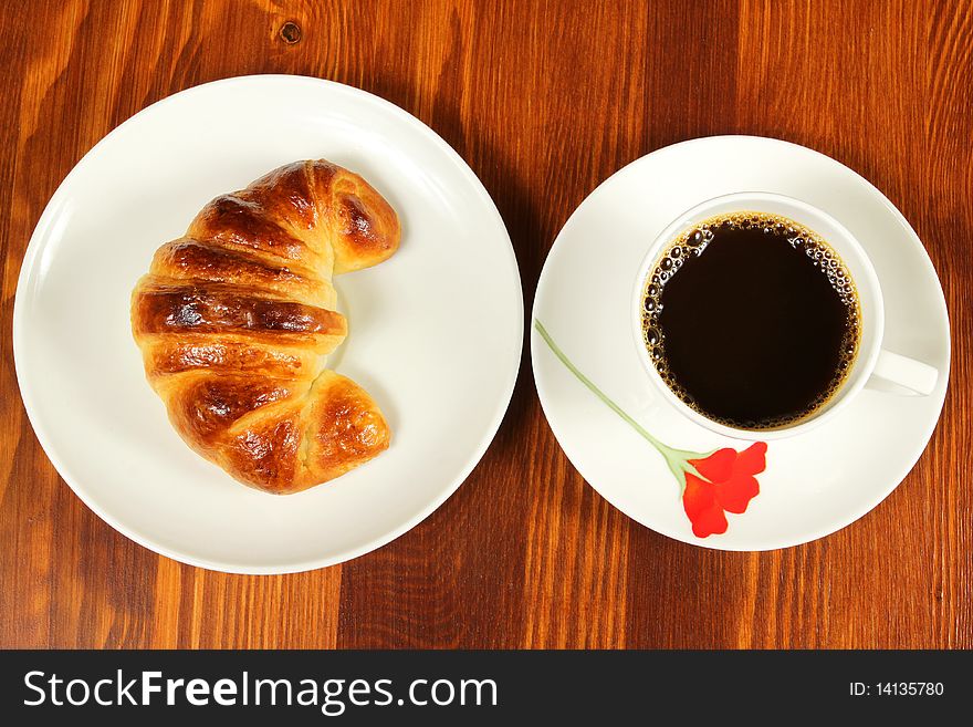 Breakfast with cup of coffee and croissant