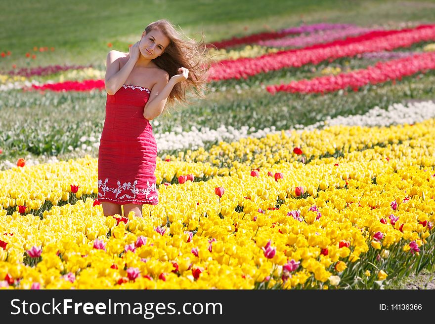 Beautiful Girl In Yellow And Red Tulips