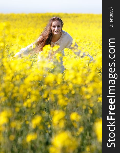 Happy girl in yellow flowers