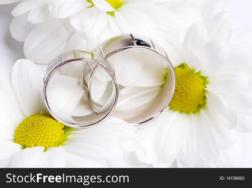 Two wedding rings with bouquet