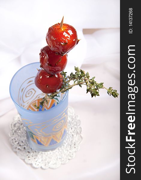 Sweet cherry tomato in colorful glass