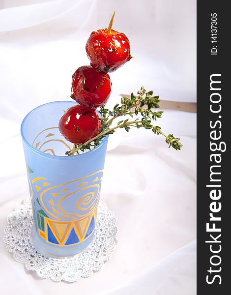 Sweet cherry tomato in colorful glass
