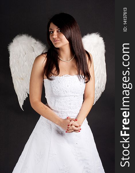 Angel with white wings on a black background