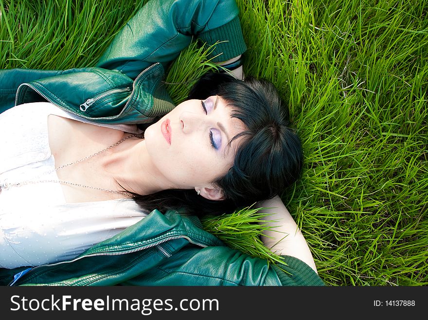 Young model laying in the grass (soft). Young model laying in the grass (soft)