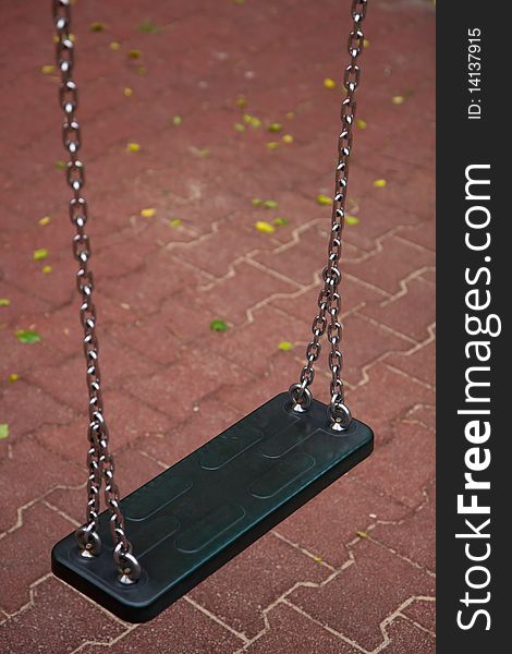 Empty swing on iron chains