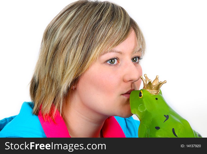 Young woman kissing a frog prince on white background. Shot in studio.