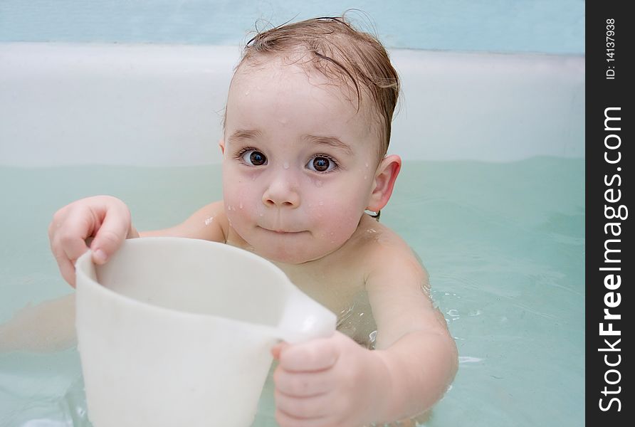 Baby is taking the bath. Baby is taking the bath