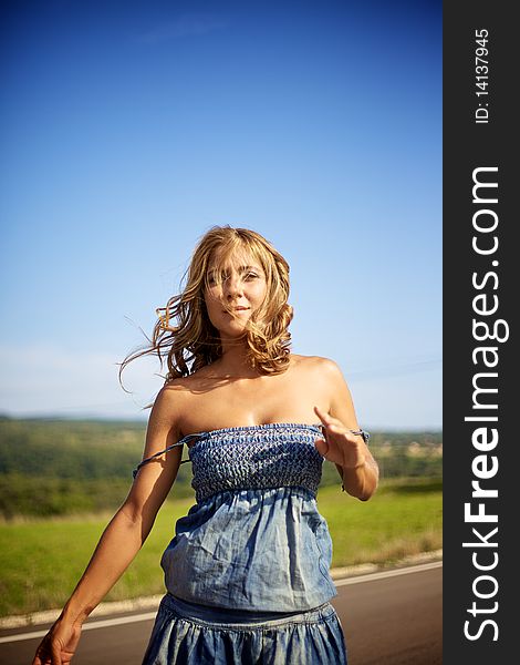 Beautiful fashion female model with blond and curly feeling a hot summer day. Beautiful fashion female model with blond and curly feeling a hot summer day