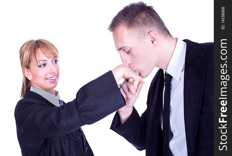 Handsome businessman kisses lady's hand , studio shot