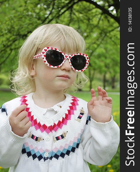 Child In Sunglasses On A Walk