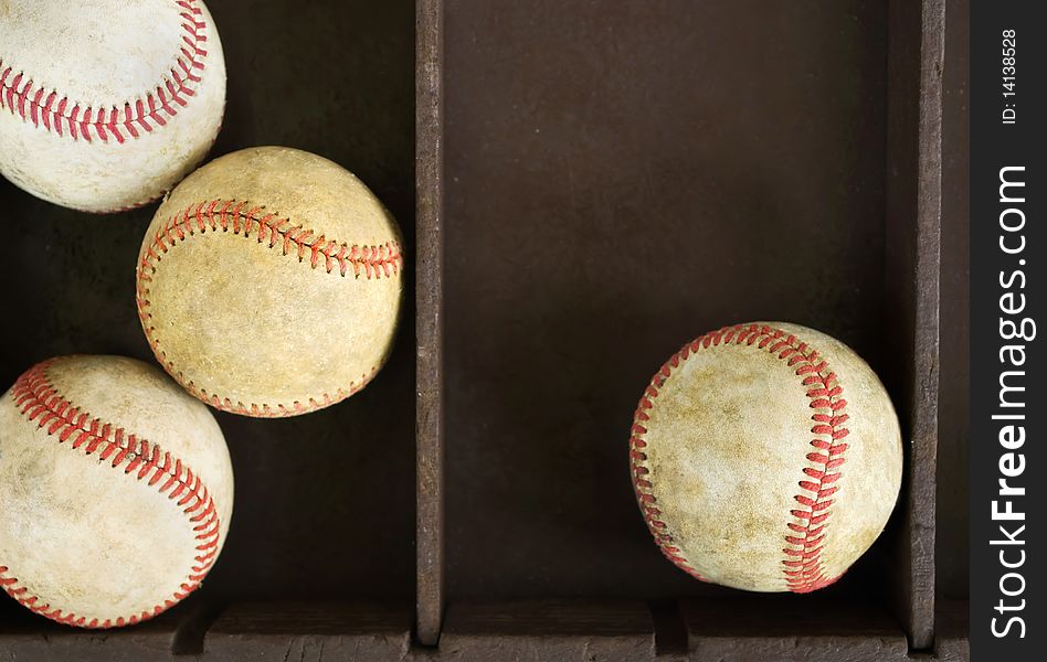 Collection of old dirty baseballs in a wooden box. Collection of old dirty baseballs in a wooden box