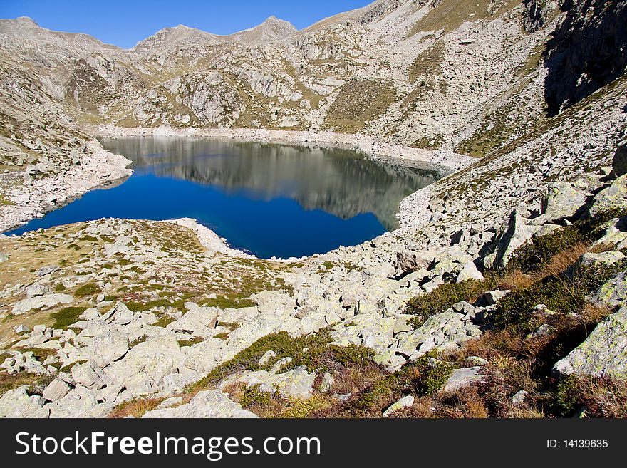 Sunny day, blue sky, mountain lake in Aiguestortes National Park. Sunny day, blue sky, mountain lake in Aiguestortes National Park.