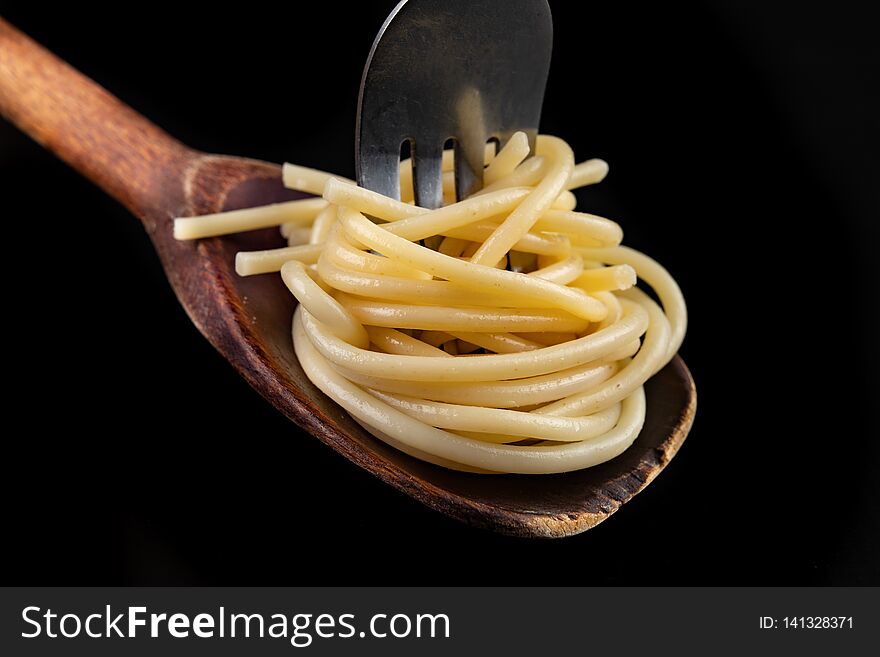 Tasty pasta on the tip of a fork. A tasty meal ready to be eaten