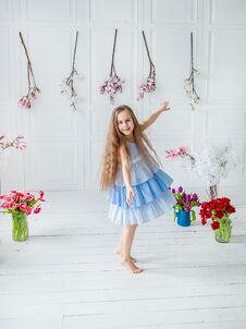 Portrait Of A Beautiful Blue-eyed Girl, A Little Girl Among Spring Flowers In A Bright Room Stock Photography
