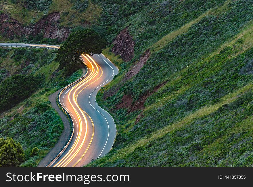 Long exposure car trails on windy mountain road