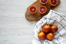 Whole And Halved Blood Oranges On A White Wooden Background, Top View. Flat Lay, Overhead, From Above. Copy Space Stock Image